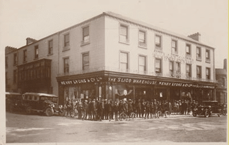 Black and white photo of people in front of a building