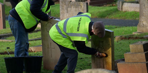 CWGC volunteer cleans a headstone.