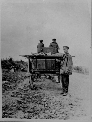 Remains covered with a Union Flag are brought for burial at a cemetery in Belgium, c. 1920. The Goodland Collection © CWGC