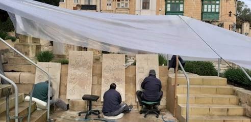 Re-engravers at work on headstones in Malta